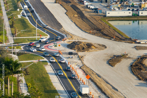 Roundabout construction roadworks on American transport infrastructure. Renovation of highway road with moving traffic. Development of interstate transportation concept