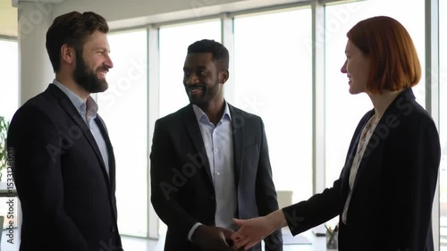Wallpaper Mural Discussing Strategy Three Professionals Talking in Office Setting. partnership, business, handshaking, agreement, handshake. Torontodigital.ca