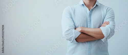 Person with crossed arms in relaxed pose indoors