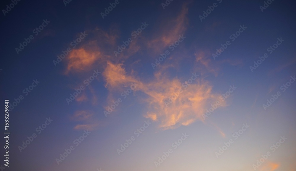Fototapeta premium yellow clouds in the blue sky, the afternoon sky with yellow clouds hit by the sunlight
