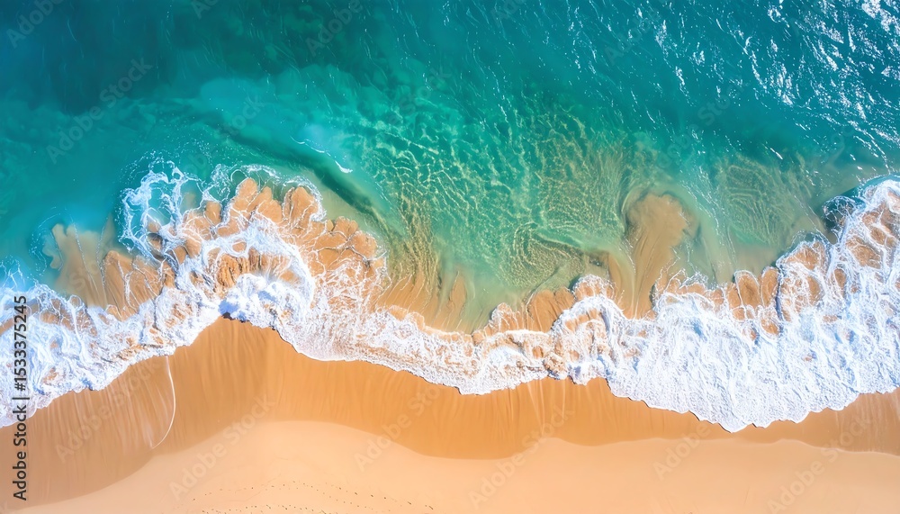 Fototapeta premium Aerial view of pristine beach with turquoise water washing over golden sand, capturing the serene beauty of nature.