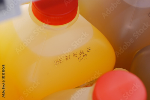 Foto Orange juice containers with expiration date in refrigerator
