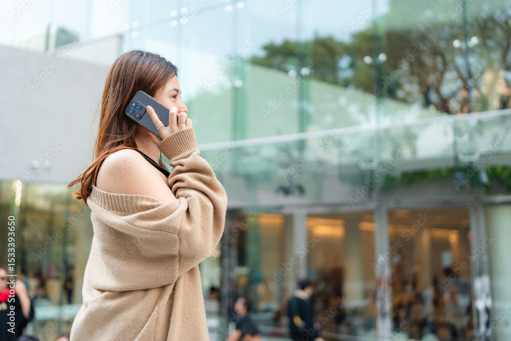 Fototapeta premium Beautiful smart business asian woman use smartphone in modern city office building