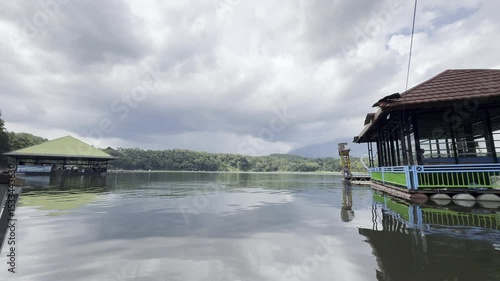 Calm Lake Landscape with Cloudy Sky. Peaceful lake landscape with cloudy sky and reflections on water, creating a calm and natural outdoor scenery.