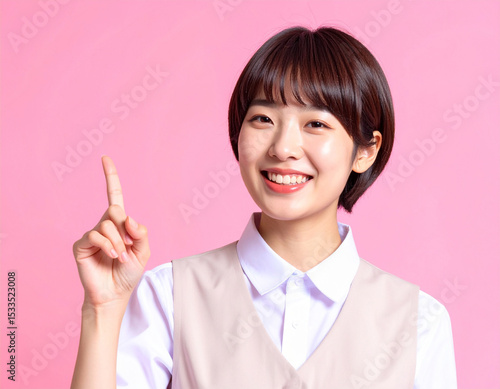 人差し指を立てるポーズをする若い女性/A young woman posing with her index finger up