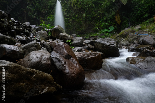 Serene Waterfall and Rocky Stream in Lush Forest