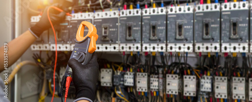 Photography Electrical technician hand checking electricity circuit breaker main power on switchboard cabinet for service maintenance and electric cable wiring check for safety concepts
