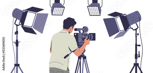 Cameraman filming with studio lighting equipment