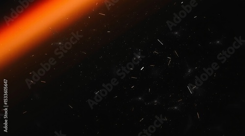 Abstract orange light leak on dark background with dust and particles