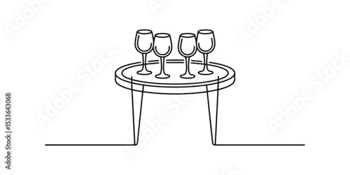 Four champagne flutes on a round side table