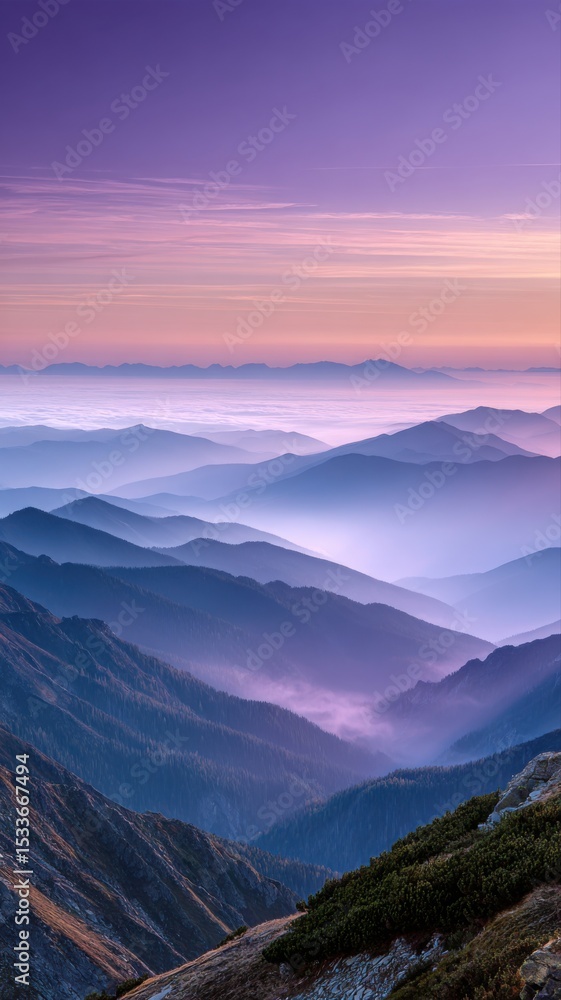 Obraz premium Dreamy mountain landscape with layers of fog and pastel colors