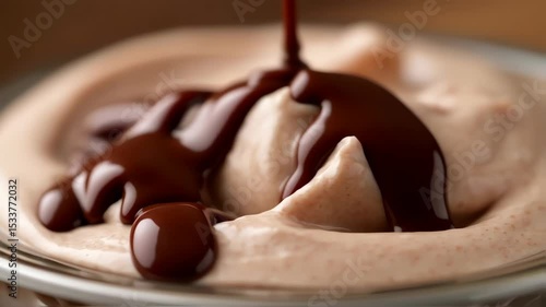 ice cream with chocolate sauce pouring on top