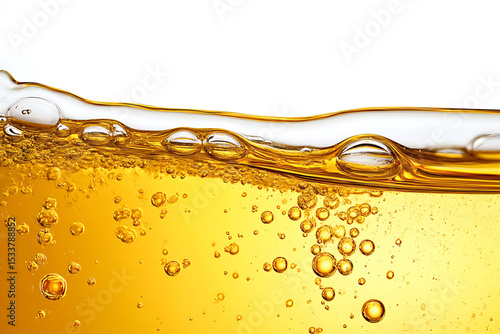 Golden liquid with air bubbles and fluid wave surface on white background. Great for drink advertising, oil textures, cosmetic serum, health concepts, or fizzy beverage designs.