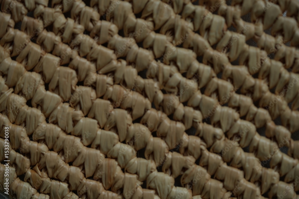 Fototapeta premium macro texture of summer brown paper hat as background, close up texture of panama hat, paper for panama hat 