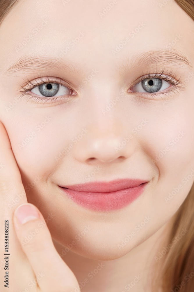 Fototapeta premium Close-up portrait beautiful Caucasian girl posing look at camera on studio, charming smile, natural beauty Gen Alpha. Face. Adverts for skincare cosmetics for teengers or children. Self care treatment