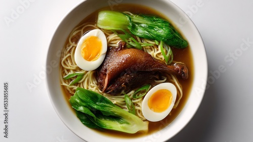 Vietnamese duck noodle soup mi vit tiem egg noodles braised duck leg and bok choy in herbal broth white background top down view