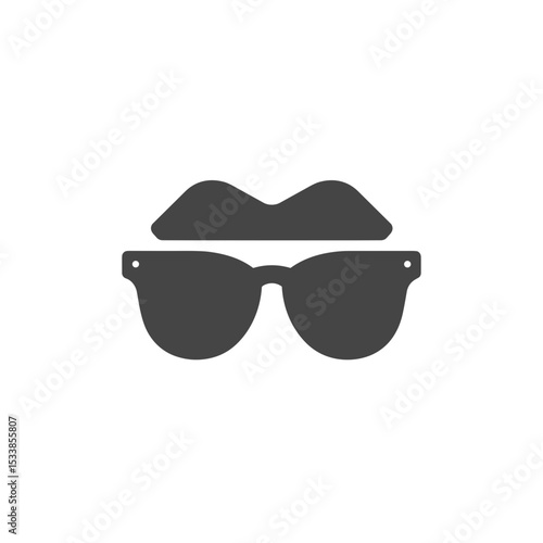 Stylish sunglasses resting on a surface, with a blurred outdoor scene in the background