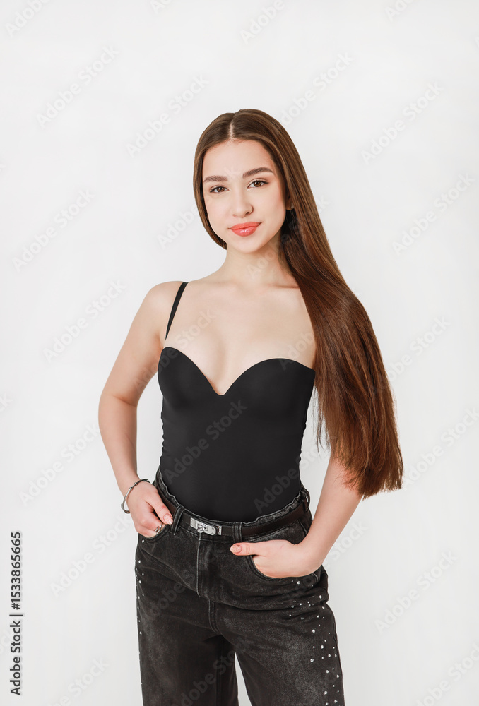 Portrait of a girl in jeans on a light background. Portrait of a girl in jeans on a light background.