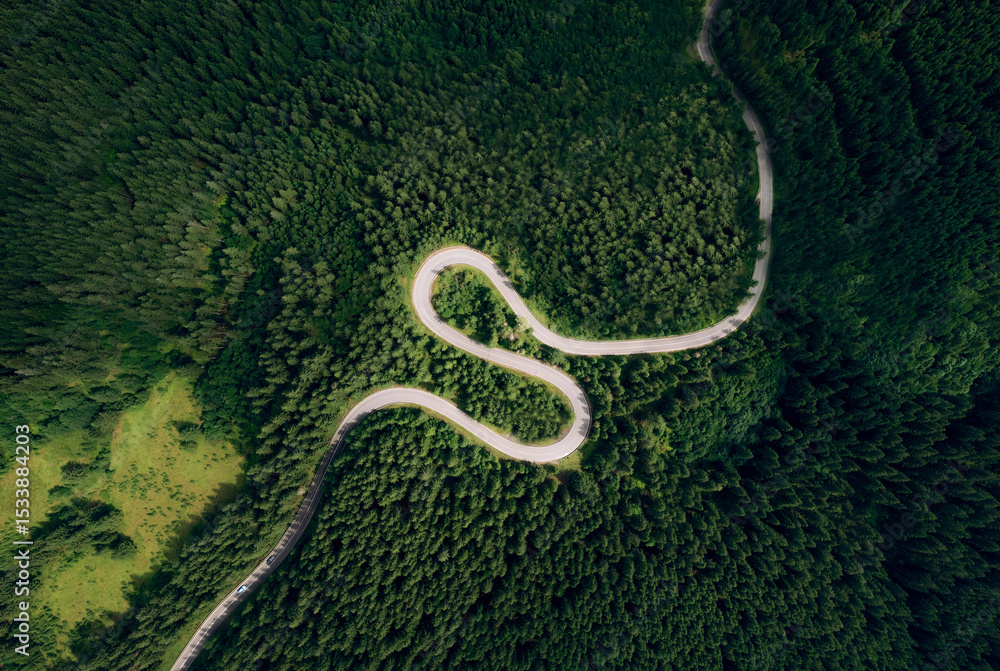 Obraz premium Curve asphalt road on mountain forest summer. Aerial view of the road passing through the mountain and green forest.