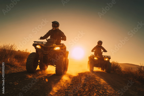 two men riding atv vehicles on dirt road during golden sunset with dust clouds and warm orange sky in desert landscape