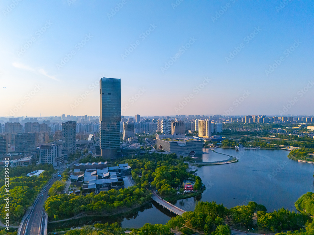 Obraz premium Aerial view of skyscrapers with beautiful lake garden at sunset, Jiading central district, Shanghai.