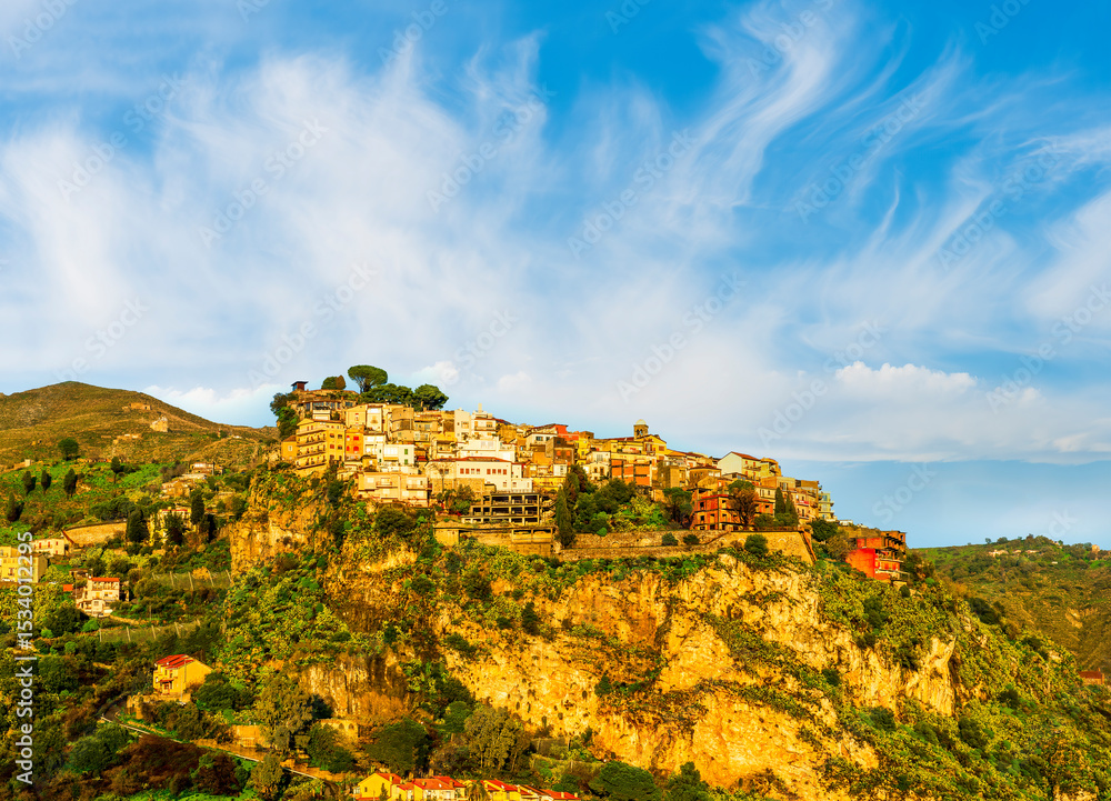 scenic morning or evening mountain town in morning or evening sun rays with yellow buildings and golden green nature background of highland scenic morning or evening mountain town in morning or evening sun rays with yellow buildings and golden green nature background of highland
