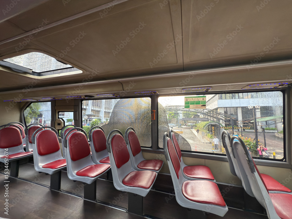 Fototapeta premium top bus row of seats, City bus interior. Public transport. top bus or tram interior without passengers. Modern public transport. Seating for passengers.