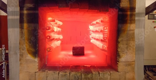 A round billet for heat treatment is heated in a red-hot furnace