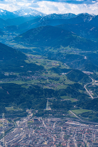 Beautiful aerial view of Innsbruck city with Bergisel ski jump and Wipptal valley from Hafelekarspitze peak in spring on a sunny day, Innsbruck, Austria