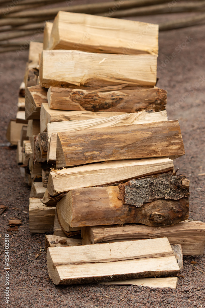 A pile of wood logs stacked on top of each other A pile of wood logs stacked on top of each other