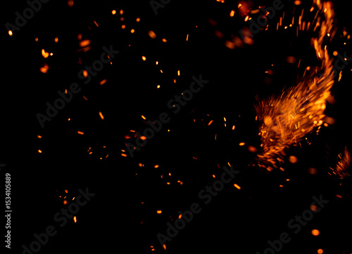 Fotografie A black background with a lot of fire and smoke