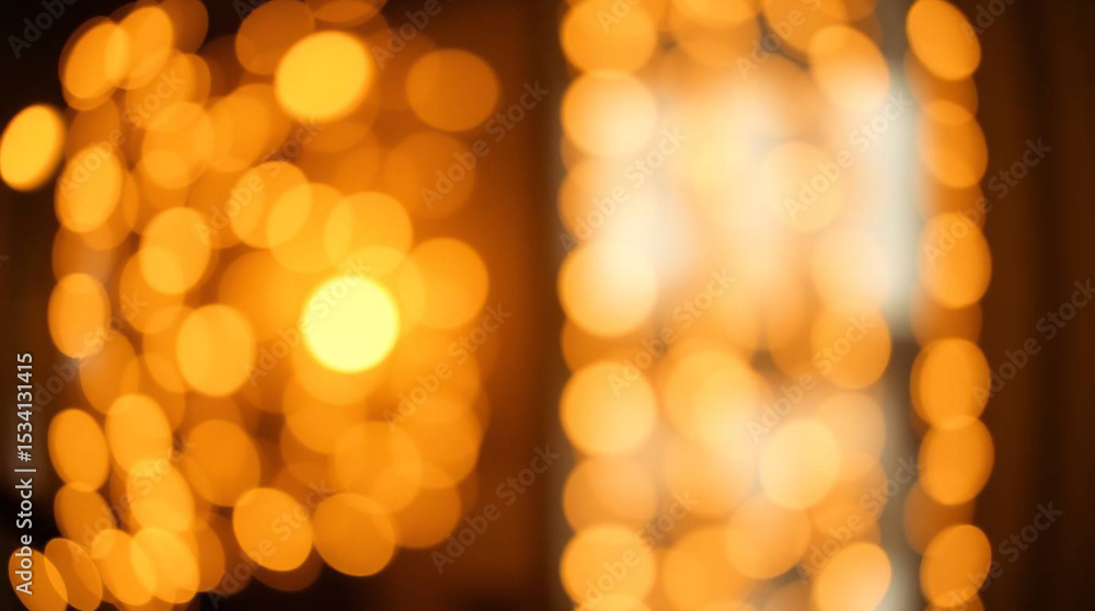 Obraz premium Abstract blurred view of warm yellow lights creating a festive and cozy atmosphere indoors