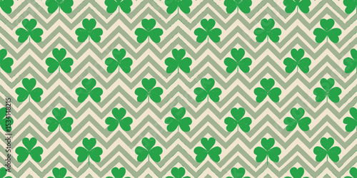 A vibrant pattern featuring green clover leaves on a zigzag background.