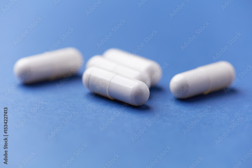 Arginine capsules on bright background. Soft focus. Close up. Copy space. Arginine capsules on bright background. Soft focus. Close up. Copy space.