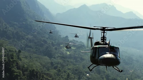 Military helicopters conduct training maneuvers over mountainous terrain during early morning hours