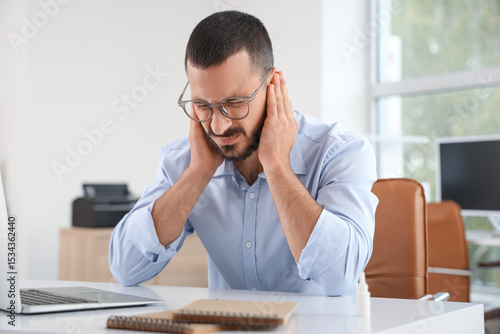 Young businessman suffering...