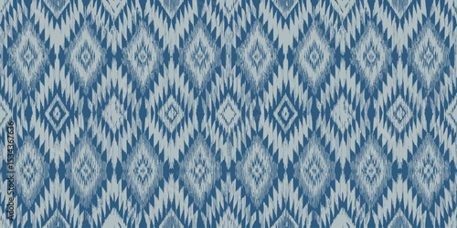 Intricate blue and white ikat pattern fabric design.