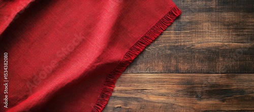 Red tablecloth draped on a wooden table