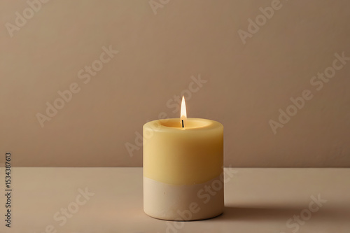 wax yellow candle on neutral surface