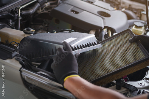 Mechanic Replacing Car Engine Air Filter.Automotive Air Filter Maintenance Process.