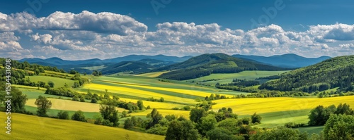 a breathtaking countryside landscape with rolling hills covered in vibrant green and yellow fields, dotted with small trees and meadows