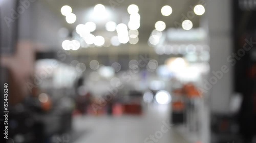Wallpaper Mural People walking in building. Building with walls, floor, ceiling illuminated lamps. Silhouettes of people indoors. Many people walking. Men and women in tall hall. Exhibition center. Blurred background Torontodigital.ca