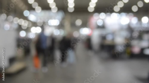 Wallpaper Mural People walking in building. Building with walls, floor, ceiling illuminated lamps. Silhouettes of people indoors. Many people walking. Men and women in tall hall. Exhibition center. Blurred background Torontodigital.ca