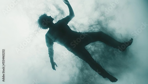 A silhouette of a person falling, surrounded by ethereal smoke