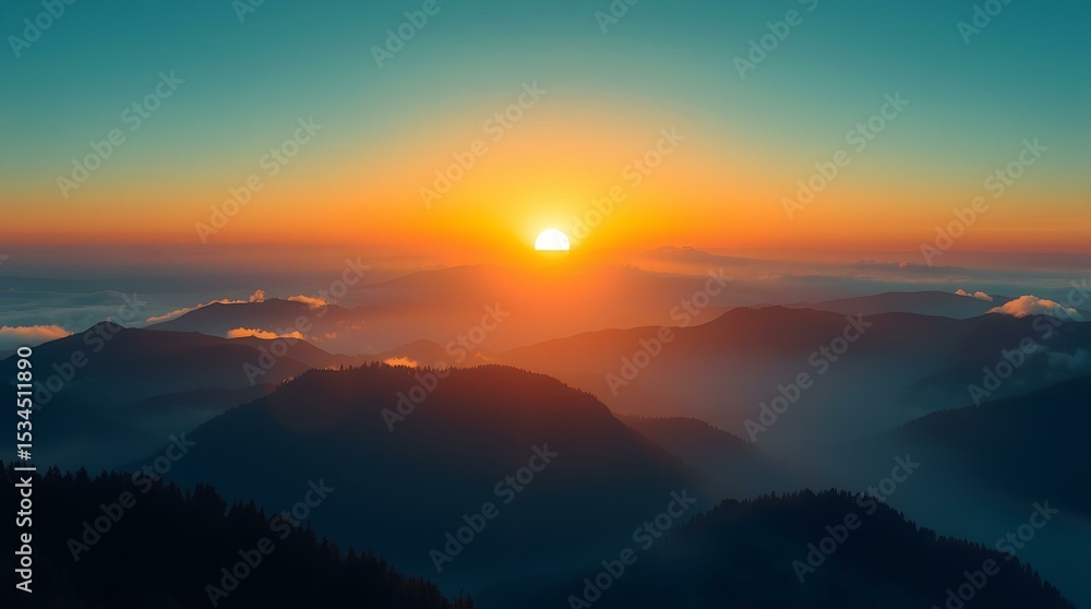 Obraz premium Golden sunrise casting light over misty mountain ridges