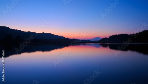 Wallpaper Mural Serene lake reflection captures beautiful twilight colors of the sky and surrounding mountains depicted in calm water Torontodigital.ca