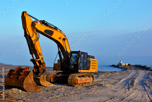 Fototapeta Naklejka Na Ścianę i Meble -  crawler excavator on the beach of cogoleto genoa italy