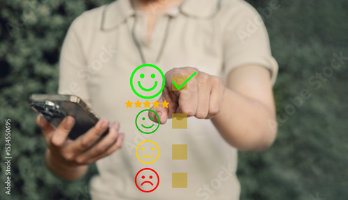 Customer service satisfaction survey concept, Rating Customer Satisfaction Online. Rating interface on mobile selecting Smiley for high satisfaction, User Rate Service Experience Online App