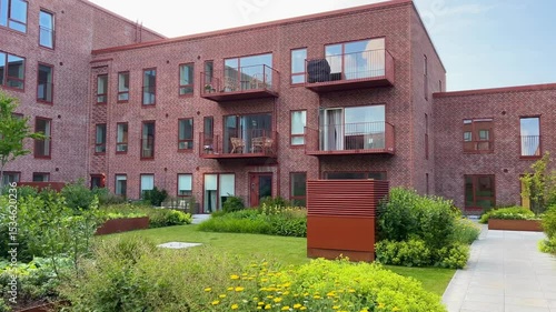 Herning, Denmark - June 12, 2025: Modern architecture apartments in Denmark summer days. Modern block of flats. A large building with a courtyard in the middle. Danish architecture design. Houses 