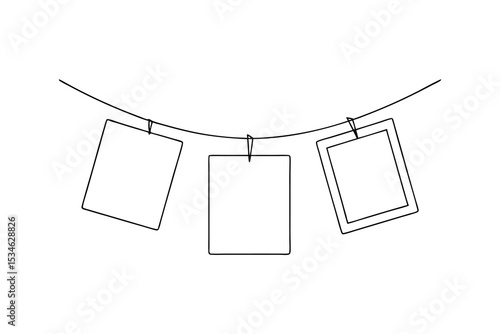 Three blank photo frames hanging on a clothesline